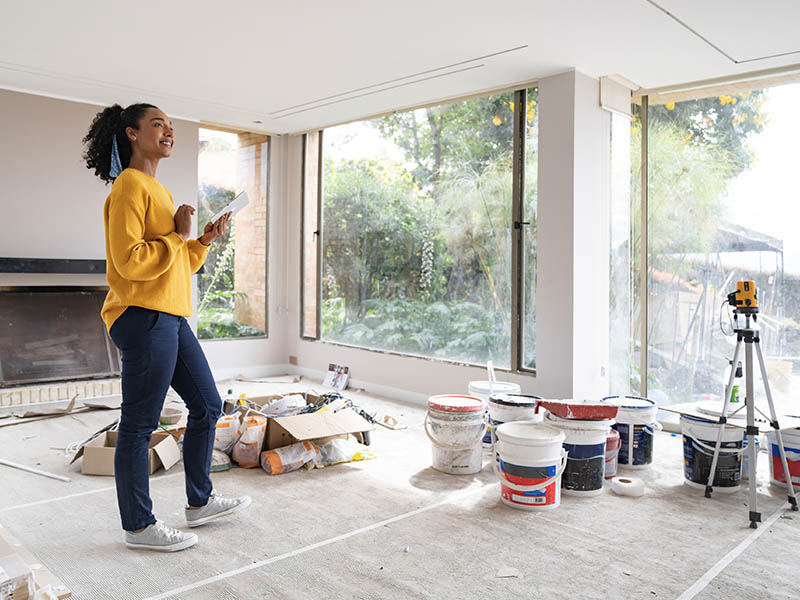 Homeowner looking around room in the middle of renovation